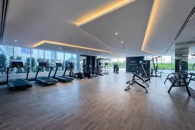 a gym with treadmills and exercise equipment in a building at Modern and Spacious Studio Al Barsha South Stay in Dubai