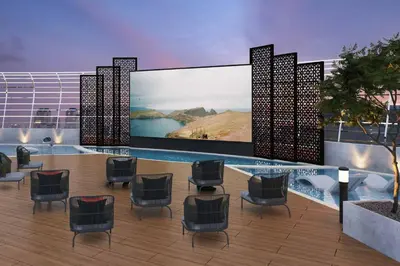 a waiting area with chairs and a pool on a building at Modern and Spacious Studio Al Barsha South Stay in Dubai