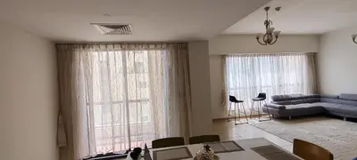 a living room with a couch and a table at JBR Skyview Rooms in Dubai