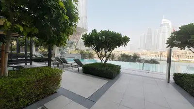 a patio with chairs and trees in a city at Luxe 1 Bedroom with High Floor close to Dubai Mall in Dubai