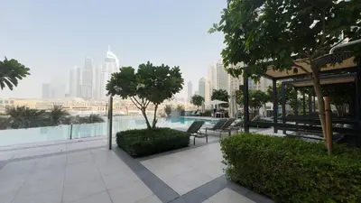 a patio with chairs and a pool in a city at Luxe 1 Bedroom with High Floor close to Dubai Mall in Dubai