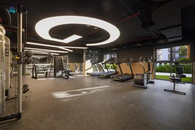 a gym with several treadmills and elliptical machines at Furnished 2BR with Vibrant View in Dubai