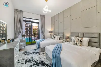 a hotel room with two beds and a balcony at Furnished 2BR with Vibrant View in Dubai