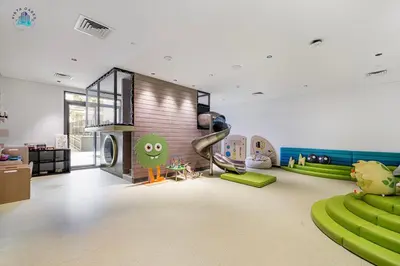 a living room with green furniture and a fireplace at Furnished 2BR with Vibrant View in Dubai