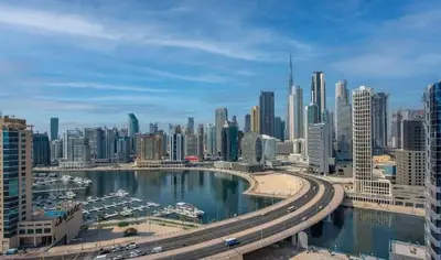 a view of a city with a river and buildings at Modern 1BR Near Burj Khalifa with Rooftop Pool, City & Canal Views, Free Parking in Dubai