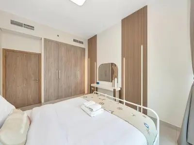 a hospital room with a bed and a mirror at Modern 1BR Near Burj Khalifa with Rooftop Pool, City & Canal Views, Free Parking in Dubai