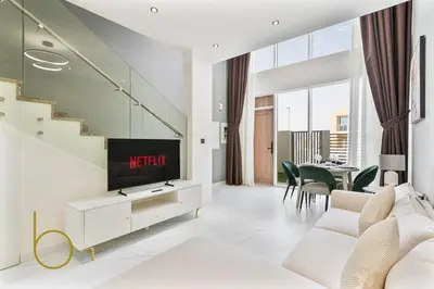 a living room with a tv and a couch at Bookable -1 Bed Rukan Townhouse with Clubhouse Access in Dubai