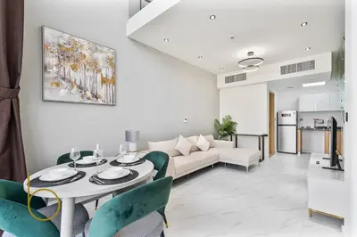 a living room with a table and a couch at Bookable -1 Bed Rukan Townhouse with Clubhouse Access in Dubai