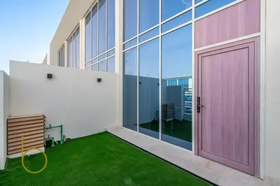 a large pink door on the side of a building at Bookable -1 Bed Rukan Townhouse with Clubhouse Access in Dubai