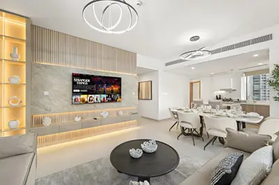 a living room with a table and a dining room at Luxe 2BR with Marina Views l Gaming & Music Room in Dubai
