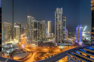 a city skyline at night with traffic at Luxe 2BR with Marina Views l Gaming & Music Room in Dubai