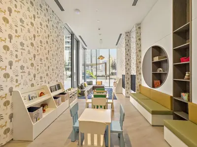 a nursery with tables and chairs and a wall of windows at Luxe 2BR with Marina Views l Gaming & Music Room in Dubai