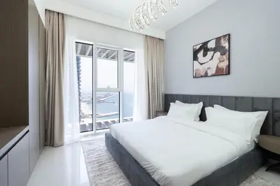 a bedroom with a bed and a large window at Keyrock - Emaar Beachfront Apartment with Sea & Palm Jumeirah Views in Dubai
