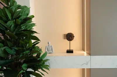 a plant sits on a shelf next to a plant at KeyRock - Dreamy Stay with Palm View - Emaar Beach in Dubai