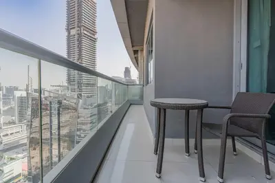 a balcony with a table and chairs in a building at TRPS - Maison Mall Street, Downtown - Close to Dubai Mall, Fully Furnished 1BR in Dubai