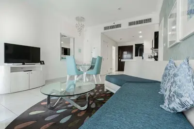 a living room with a couch and a table at TRPS - Maison Mall Street, Downtown - Beautifully Appointed 1BR, Near to Burj Khalifa in Dubai