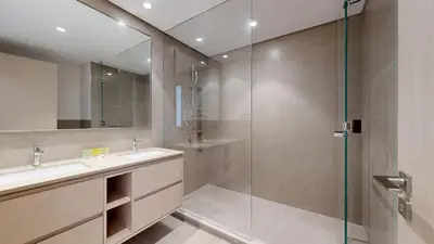 a bathroom with a sink and a glass shower at Exclusive Burj Khalifa View Luxury 2BR Next to Dubai Mall - Like Home in Dubai