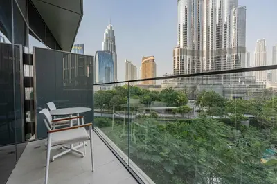 a balcony with a table and a view of a city at TRPS - Address Opera, Downtown - Burj Khalifa View, Luxury 3BR Living in Dubai