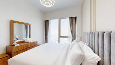 a bedroom with a bed and a large window at Panaromic Burj Khalifa View from Balcony - Luxury 2BR next to Dubai Mall - Like Homes in Dubai