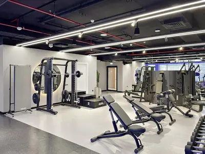 a gym with several treadmills and exercise bikes at Stylish 1BR in Hamilton House in Dubai