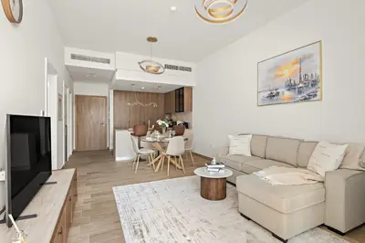 a living room with a couch and a table at Stylish 1BR in Hamilton House in Dubai
