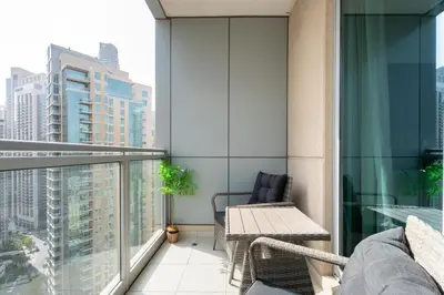 a balcony with a table and chair on a building at GuestReady - Downtown View | 1BR + Sofa Bed in Dubai