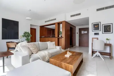 a living room with a couch and a table at GuestReady - Downtown View | 1BR + Sofa Bed in Dubai