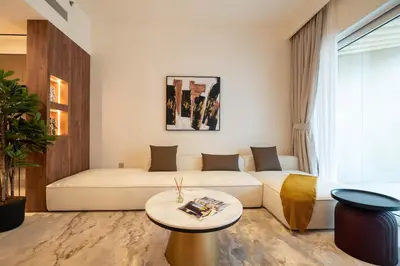a living room with a white couch and a table at KeyRock - Palm View Luxury Stay in Grand Bleu in Dubai