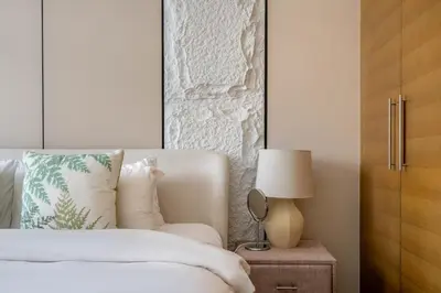 a bedroom with a bed and a table with a lamp at DAYF-CLA Stylish Apartment for 4 Guests in Central Location in Dubai