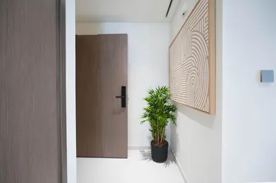 a hallway with a door and a potted plant at KeyRock - Grand Bleu Escape with Iconic Palm Views in Dubai