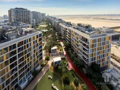 an aerial view of a city with buildings and the beach at Brand New High Floor Studio in Midtown Dubai in Dubai