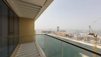 a balcony in a building with a view of the city at Elegant Seaside Luxury 1BR in Beachfront, Grand BLeu Tower, Pool & Gym in Dubai
