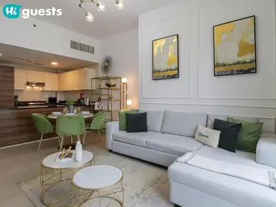 a living room with a couch and a table at HiGuests - Marina View 1 BR with Spacious Balcony in Dubai