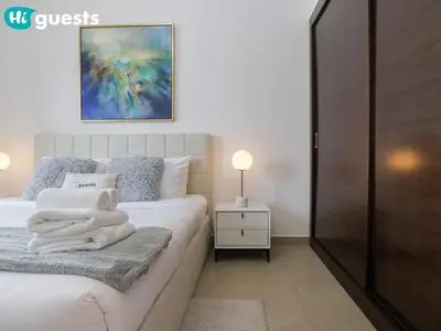 a bedroom with a bed with towels on it at HiGuests - Marina View 1 BR with Spacious Balcony in Dubai