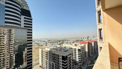 a view of a city from a building at Lovely Studio with balcony in Silicon Oasis in Dubai