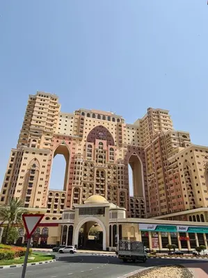 a large building with many windows on a street at Lovely Studio with balcony in Silicon Oasis in Dubai