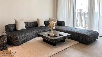 a living room with a couch and a table at Luxury Apartment in CREEK Harbour in Dubai