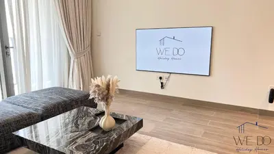 a living room with a couch and a table at Luxury Apartment in CREEK Harbour in Dubai