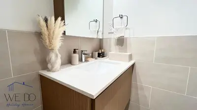 a bathroom with a white sink and a mirror at Luxury Apartment in CREEK Harbour in Dubai