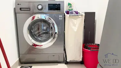 a washer and dryer in a room at Luxury Apartment in CREEK Harbour in Dubai