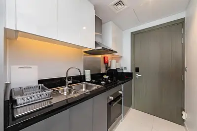 a kitchen with a sink and a counter top at Studio Apartments with City View at DAMAC Maison Prive in Dubai