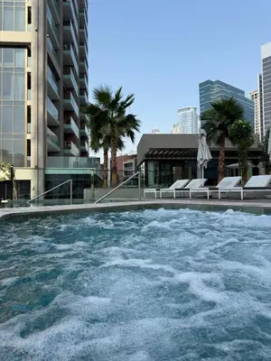 a pool of water with buildings in the background at Hububb Luxury Peninsula 5 Dubai in Dubai