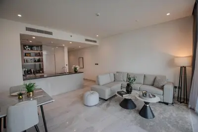 a living room with a couch and a table at Hububb Luxury Peninsula 5 Dubai in Dubai