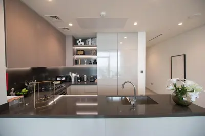 a kitchen with a sink and a counter top at Hububb Luxury Peninsula 5 Dubai in Dubai
