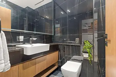 a bathroom with a sink and a toilet at Silkhaus Modern 1BDR Stay in JVC in Dubai