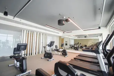 a gym with a bunch of exercise equipment in it at Beach Vista - One Bed with Infinity Pool Access in Dubai