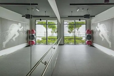 a hallway with a glass door with a view of the ocean at Beach Vista - One Bed with Infinity Pool Access in Dubai