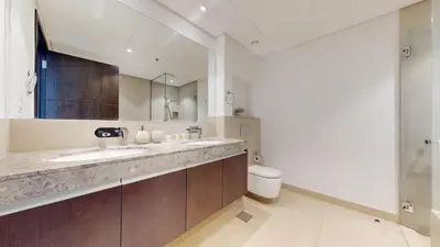 a bathroom with a sink and a toilet at Creek Residences - Opulent Two Bed with Creek View in Dubai