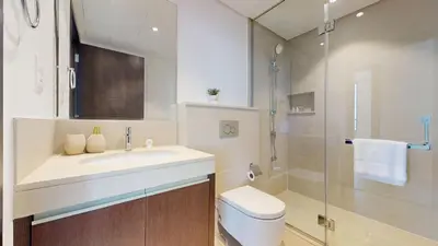 a bathroom with a sink and a toilet and a shower at Creek Residences - Opulent Two Bed with Creek View in Dubai