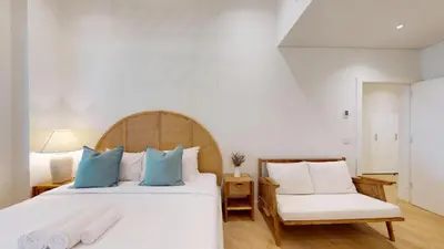 a bedroom with a large white bed with blue pillows at Al Dabas 2 - Calm One Bedroom in Palm Jumeirah in Dubai